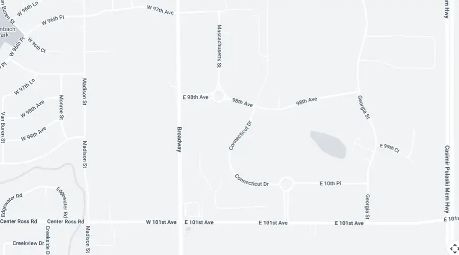 A section of a street map showing roads including Broadway, Massachusetts St, Connecticut Dr, and E 98th Ave, with labeled intersections and a small body of water.